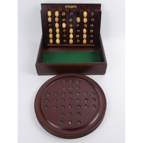 394A - Remy Martin wooden Le Passe Temps game and a 26cm mahogany solitaire board, 28.5cm x 22.5cm x 7cm.