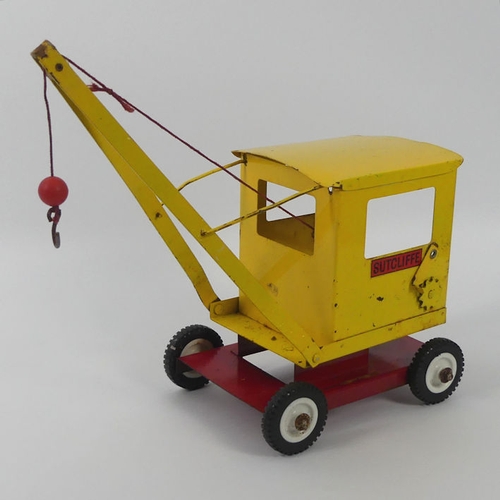 395 - A Sutcliffe tin plate crane, 31cm x 29cm.