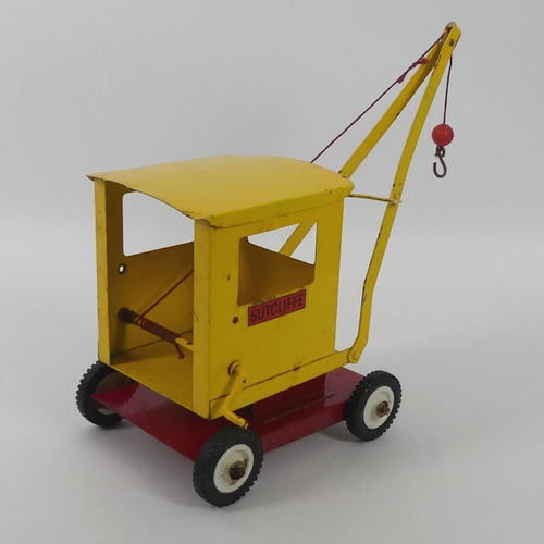 395 - A Sutcliffe tin plate crane, 31cm x 29cm.