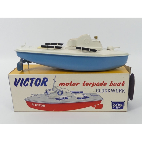 397 - A boxed Sutcliffe Victor torpedo tin plate clockwork boat, 24cm x cm.