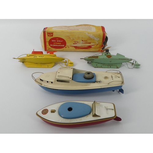 399 - Four Sutcliffe tin plate clockwork boats, including a Sea Wolf submarine, 31cm x 12cm.