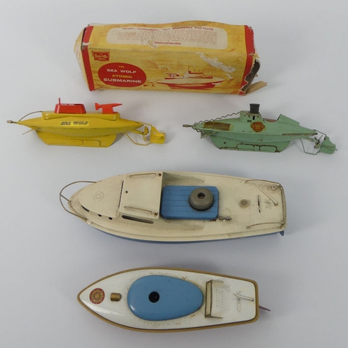 399 - Four Sutcliffe tin plate clockwork boats, including a Sea Wolf submarine, 31cm x 12cm.