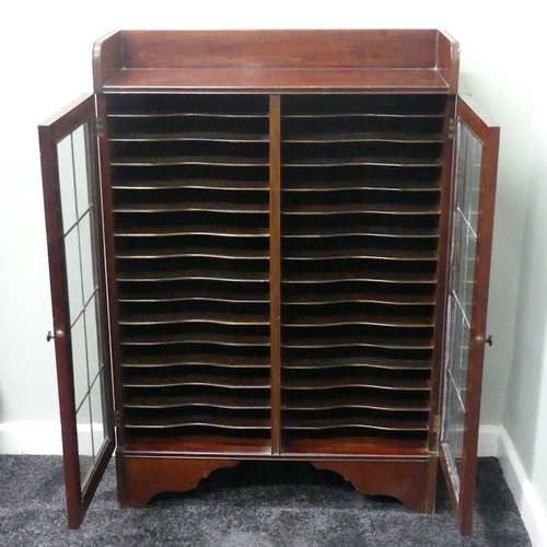 499 - A mahogany fitted bookcase holding thirty-two volumes of Encyclopaedia Britannica with suede covers,... 