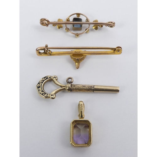 20 - A 9ct fox design bar brooch, a 9ct gold topaz and seed pearl brooch, a 9ct Victorian watch key and a... 