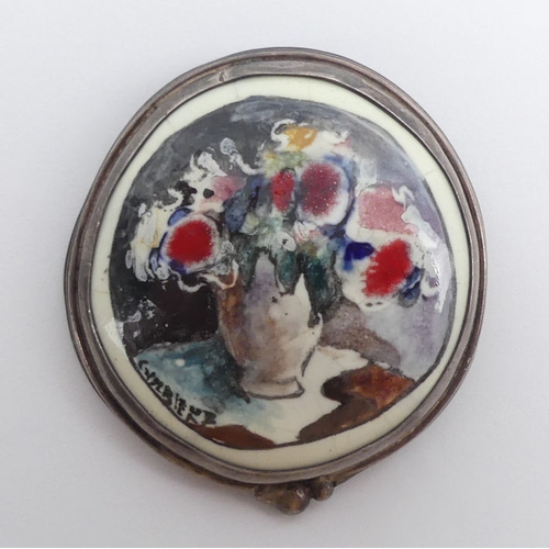 28 - A silver mounted Corbiero signed floral pottery brooch, 21.5 grams, 43mm x 48mm.