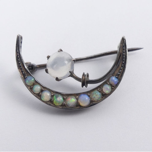 32 - A Victorian sterling silver moonstone and opal crescent brooch, 2.6 grams, 25mm.