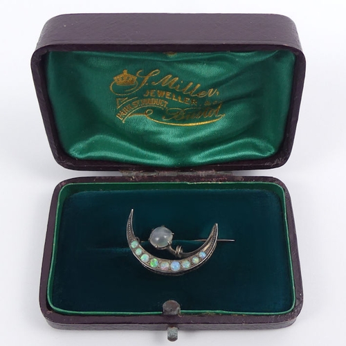 32 - A Victorian sterling silver moonstone and opal crescent brooch, 2.6 grams, 25mm.