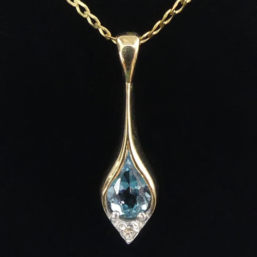 42 - 9ct gold, blue topaz and diamond pendant and chain, 2.1 grams.