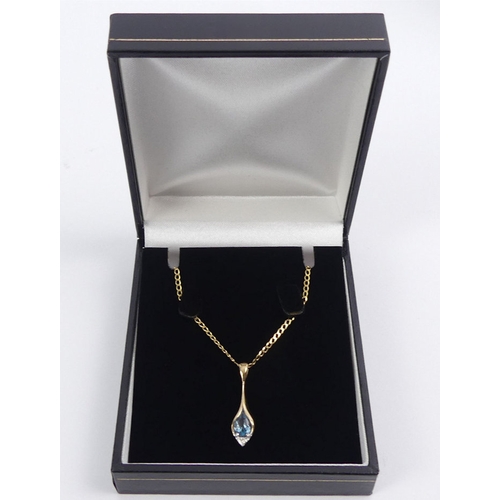 42 - 9ct gold, blue topaz and diamond pendant and chain, 2.1 grams.