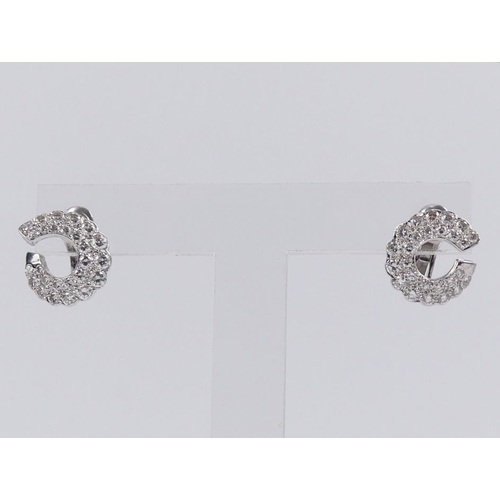 44 - A pair of 18ct white gold (tested) graduated diamond 'C' design earrings, 6 grams, 14.8mm.