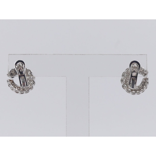 44 - A pair of 18ct white gold (tested) graduated diamond 'C' design earrings, 6 grams, 14.8mm.