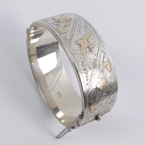 46 - Silver, with gilt metal decoration floral hinged bangle, Chester 1959, 35.1 grams, 22.5mm.