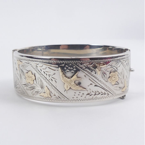 46 - Silver, with gilt metal decoration floral hinged bangle, Chester 1959, 35.1 grams, 22.5mm.