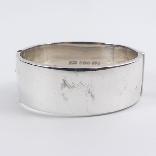 46 - Silver, with gilt metal decoration floral hinged bangle, Chester 1959, 35.1 grams, 22.5mm.