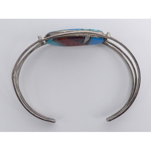 20 - Native American silver (tested), multi-coloured stone set double sided swivel cuff bangle and a turq... 