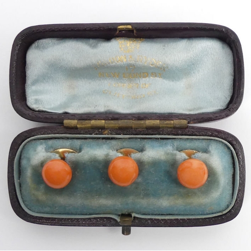 36 - Three Victorian yellow metal and coral studs in the original box, 4.7 grams, 10.8m diameter.