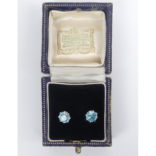 59 - A pair of 9ct white gold, blue topaz stud earrings, 2.2 grams, 7.1mm diameter.