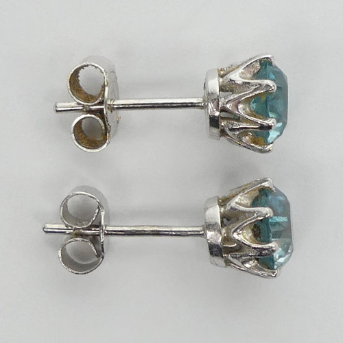 59 - A pair of 9ct white gold, blue topaz stud earrings, 2.2 grams, 7.1mm diameter.