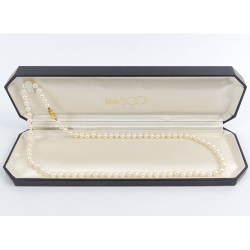 60A - A Lotus pearl necklace with a 9ct gold clasp and original presentation box, 23.5 grams, 60 cm x 5.9 ... 