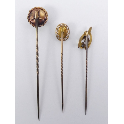 79 - Three gold topped stick pins, one set with a diamond, largest 12.5mm diameter.