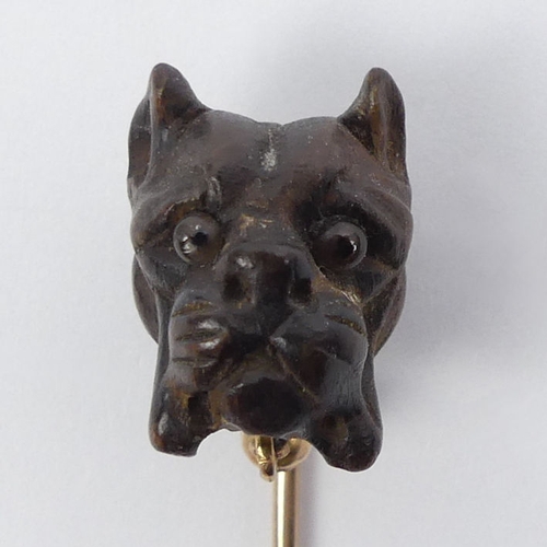 80 - A gold mounted stick pin, carved with a Bulldog,  1.8 grams, 70mm long, top 12.7mm x 17.3mm.