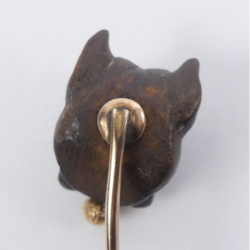 80 - A gold mounted stick pin, carved with a Bulldog,  1.8 grams, 70mm long, top 12.7mm x 17.3mm.