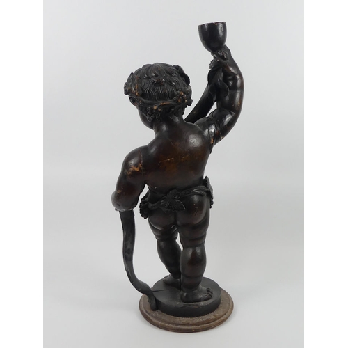 241 - A carved wooden advertising figure of Bacchus, holding a goblet and banner, which reads wines and fo... 