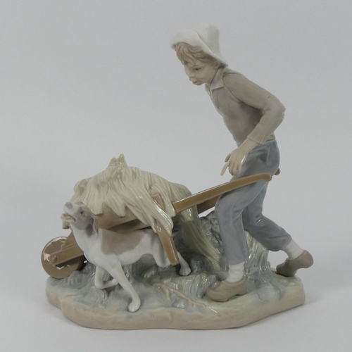 316 - A Lladro figure of a boy with a loaded wheelbarrow and dog, 24 cm x 20 cm.