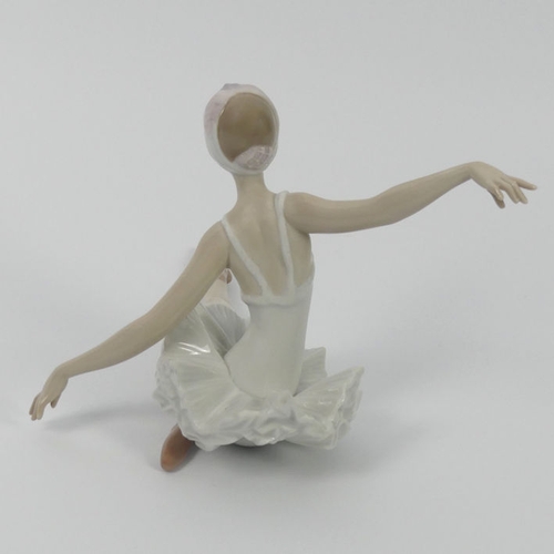 318 - A Lladro figure of a ballerina with outstretched arms, 19 cm x 15 cm.