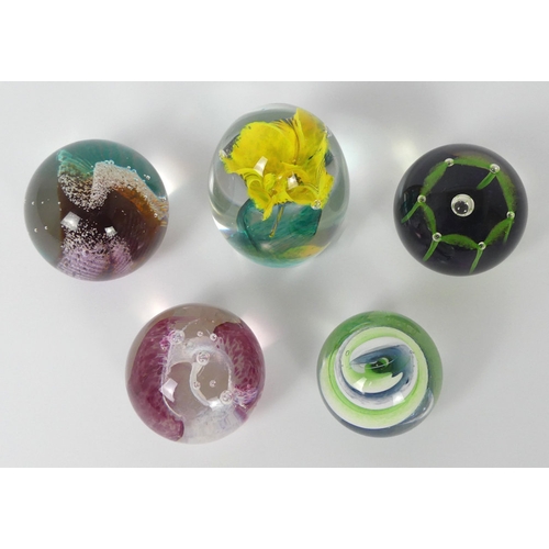 Five glass paperweights, including Caithness examples, tallest 10cm.