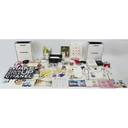 A collection of Chanel bags, boxes and ribbons along with some samples.