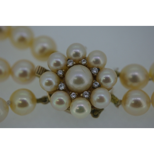 133 - Triple string pearl necklace with gold and diamond clasp, in need of restringing - length 14.25 ins.