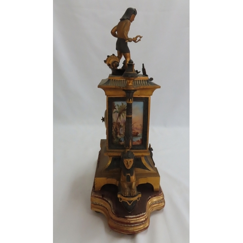 180 - A 19thC French ormolu and bronze mantel clock with Egyptian decoration, porcelain dial chiming on a ... 