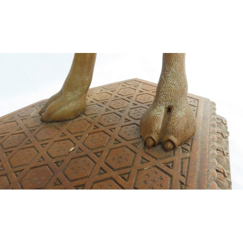 202 - An Anglo-Indian carved teak occasional table modelled as a camel, circa 1900. The octagonal top and ... 