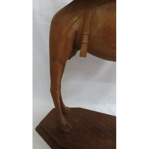 202 - An Anglo-Indian carved teak occasional table modelled as a camel, circa 1900. The octagonal top and ... 