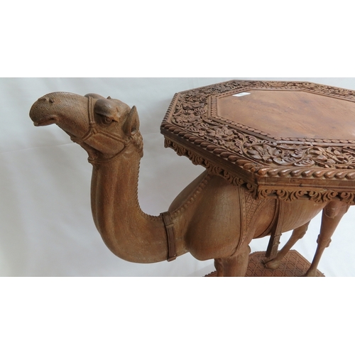 202 - An Anglo-Indian carved teak occasional table modelled as a camel, circa 1900. The octagonal top and ... 