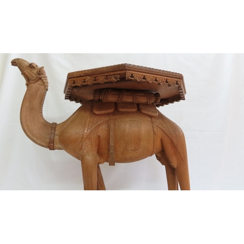 202 - An Anglo-Indian carved teak occasional table modelled as a camel, circa 1900. The octagonal top and ... 