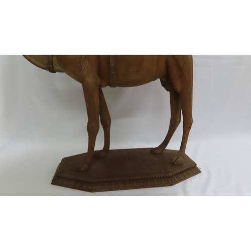 202 - An Anglo-Indian carved teak occasional table modelled as a camel, circa 1900. The octagonal top and ... 