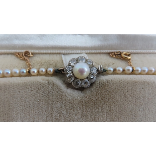 205 - Early 20thC graduated pearl necklace with diamond clasp - length 18 ins.