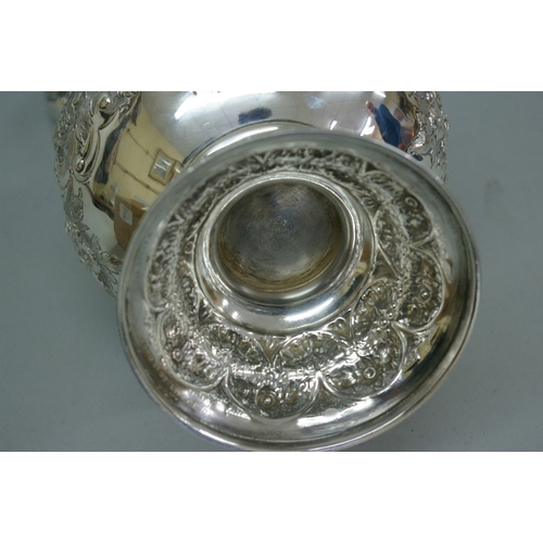 28 - Good Victorian chased silver claret jug with decoration of angels, lion mask in relief, acanthus, fl... 