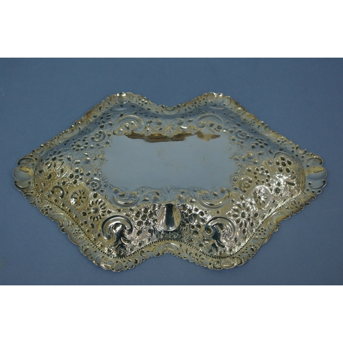 34 - A Victorian chased silver bread dish of shaped oval form with floral, C scroll and shell decoration.... 