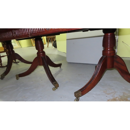 242 - 19thC mahogany triple pedestal dining table with extra leaf on reeded sabre legs and brass castor ex... 