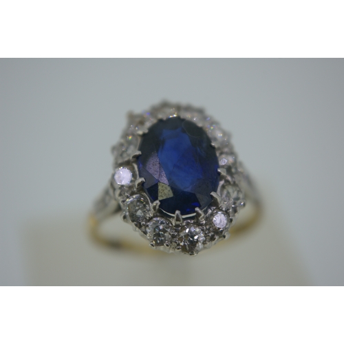 249 - Oval sapphire and diamond cluster ring set in 18ct gold 9 (good colour sapphire), size J