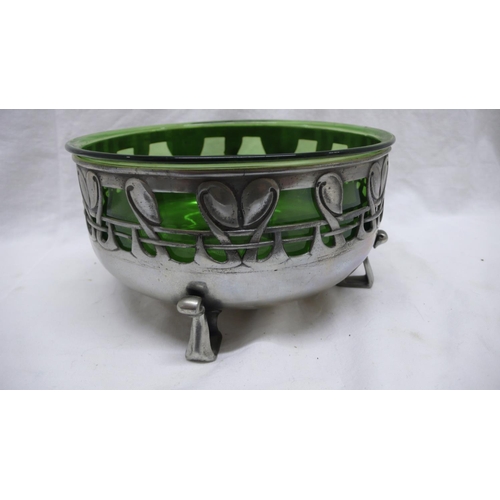 35 - Liberty & Co. Tudric Pewter fruit bowl with green glass liner and pierced foliate decoration on four... 