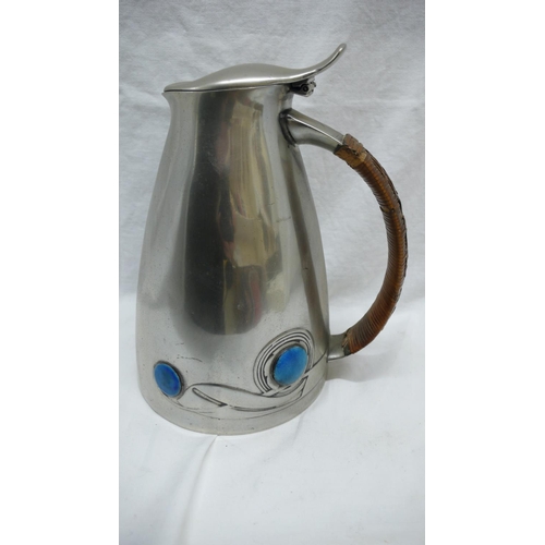 46 - Archibald Knox for Liberty & Co. pewter hot water jug with swelling conical body, cane handle and bl... 