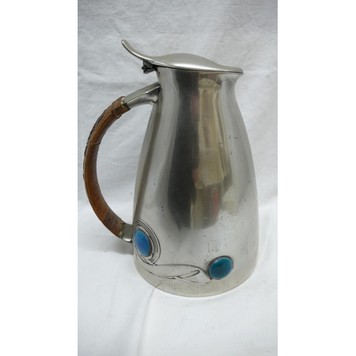 46 - Archibald Knox for Liberty & Co. pewter hot water jug with swelling conical body, cane handle and bl... 