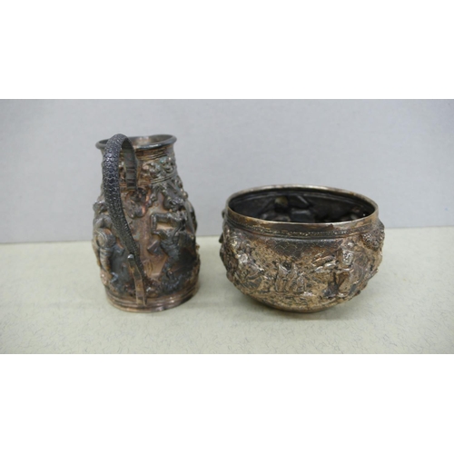 39 - Indian silver cream jug and sugar with decoration of figures in relief - Ht. of Jug 2.25 ins