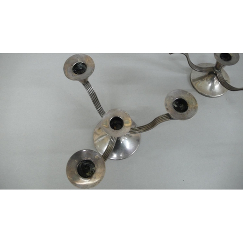 54 - A pair of designer silver three branch candelabra with three reeded arms on circular base.  Birmingh... 