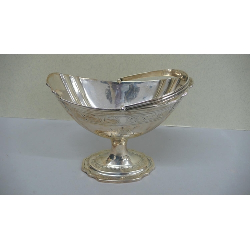 87 - GIII Irish Silver oval fluted swing handled sugar basket with  engraved scroll decoration to border ... 