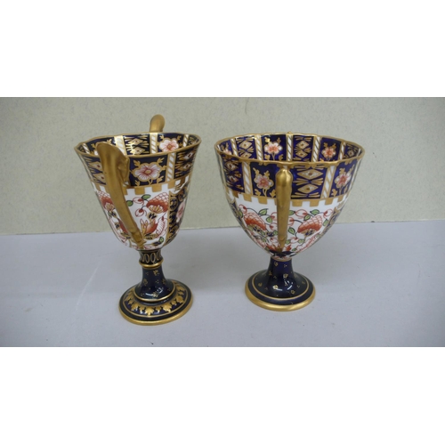 102 - Two Royal Crown Derby porcelain Imari pattern two handled goblets - 1909 & 1911 - Ht. 5 ins